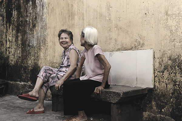 Two elders are seen talking to each other in Tue Hoa Ly alley on Nguyen Trai Street, District 5, in this photo.