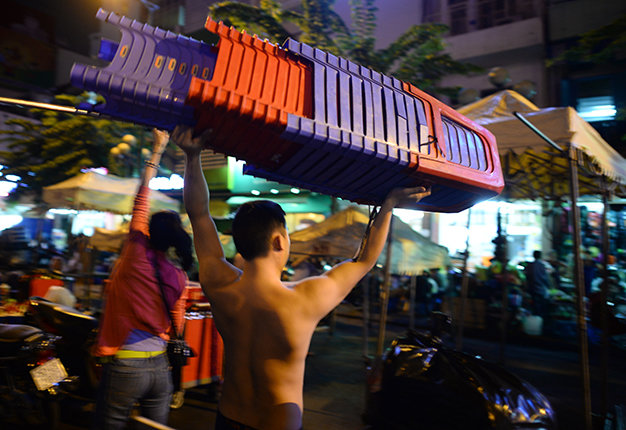 Muscular young men are hired to set up stalls for around VND3 million (US$140) a month.