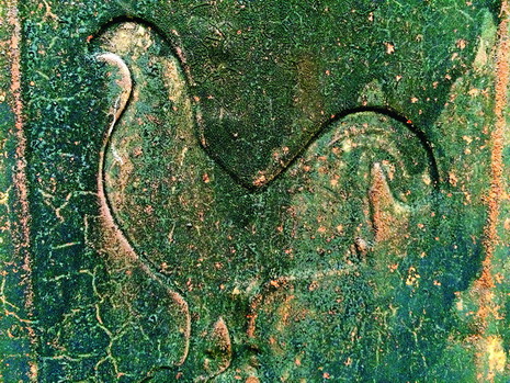 A weather-beaten image of a cock is seen on the wall of an age-old house in Da Lat.