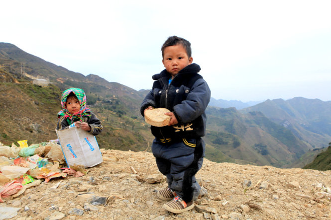 Two little kids are pictured along the way to Xin Cai Commune.