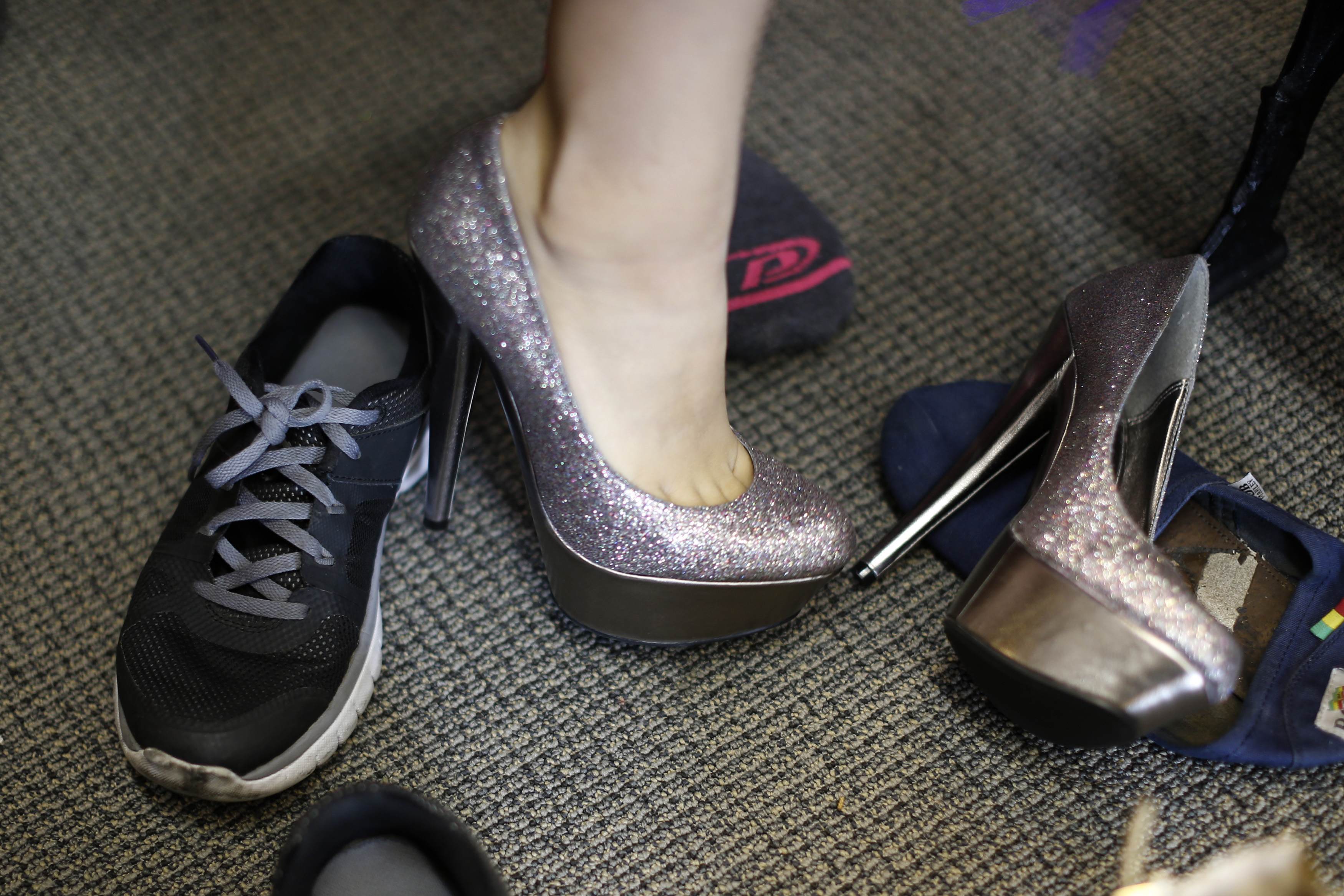 A girl tries on stilettos at an event that provides free prom dresses, shoes and accessories to 70 homeless and low income school girls from the Assistance League of Los Angeles in Los Angeles, California March 5, 2015.