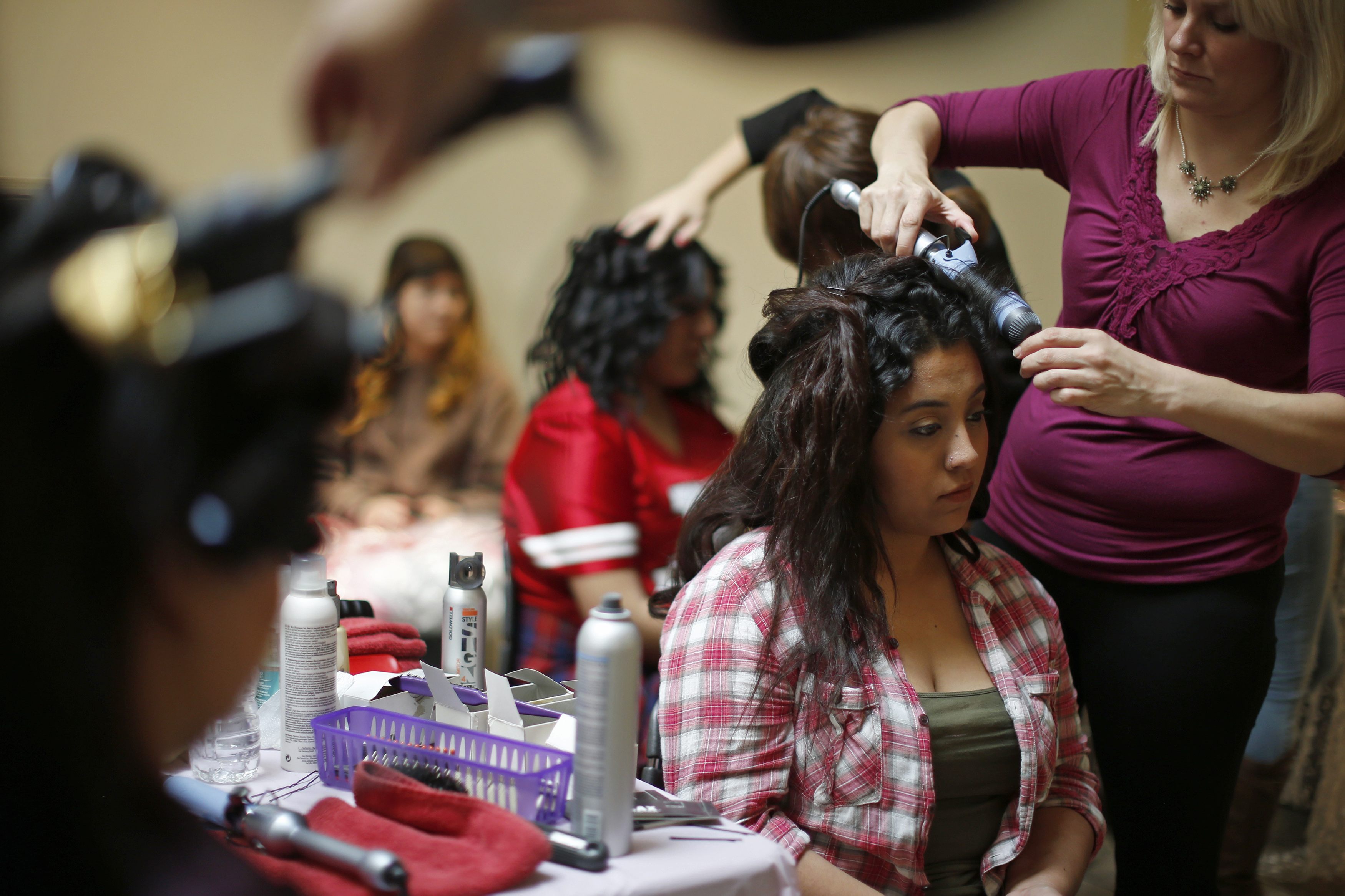 Adona Vazquez, 17, tries on a dress at an event that provides free prom dresses, shoes and accessories to 70 homeless and low income school girls from the Assistance League of Los Angeles, California March 5, 2015.
