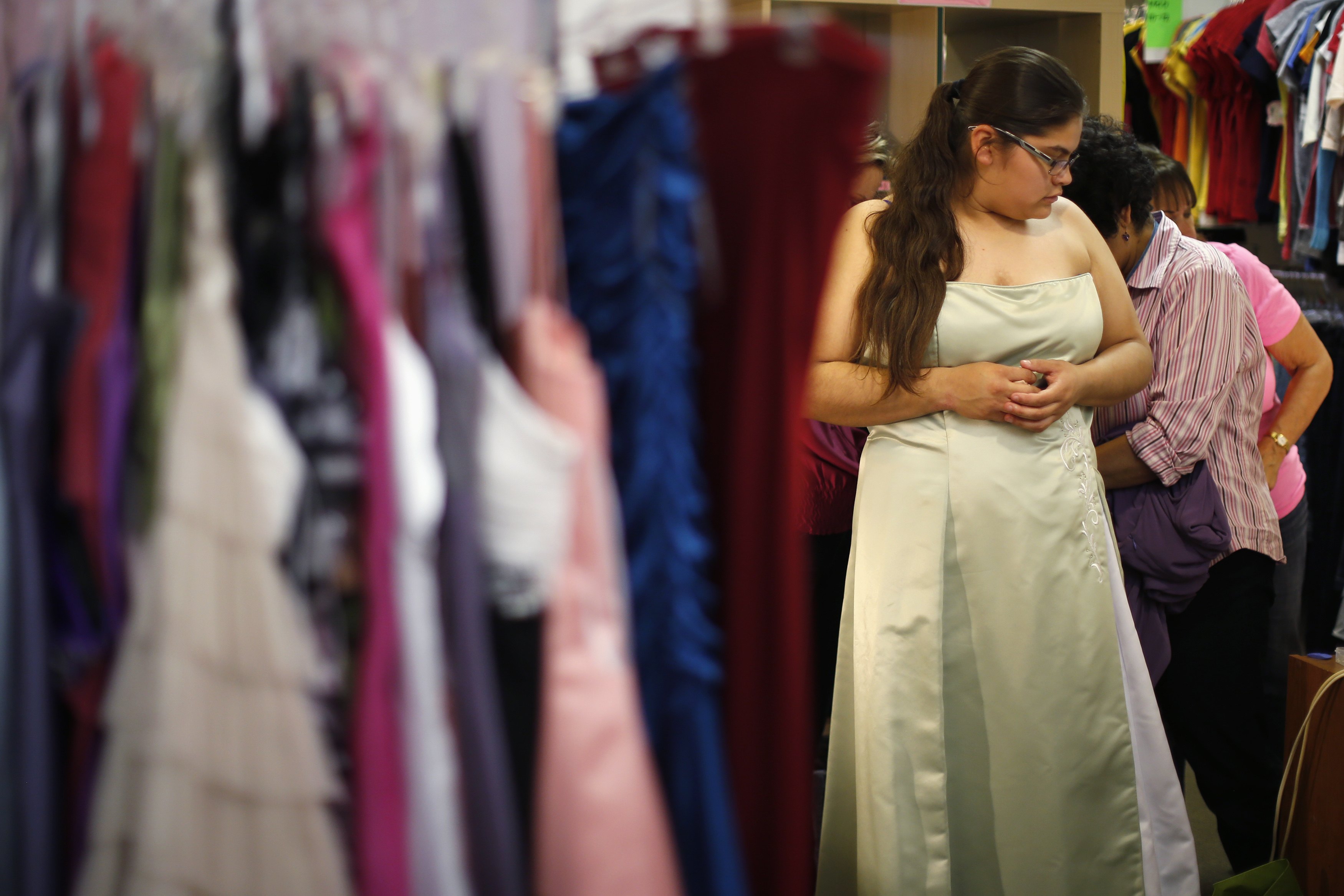 Perla Oseguera, 19, tries on a dress at an event that provides free prom dresses, shoes and accessories to 70 homeless and low income school girls from the Assistance League of Los Angeles, California March 5, 2015.
