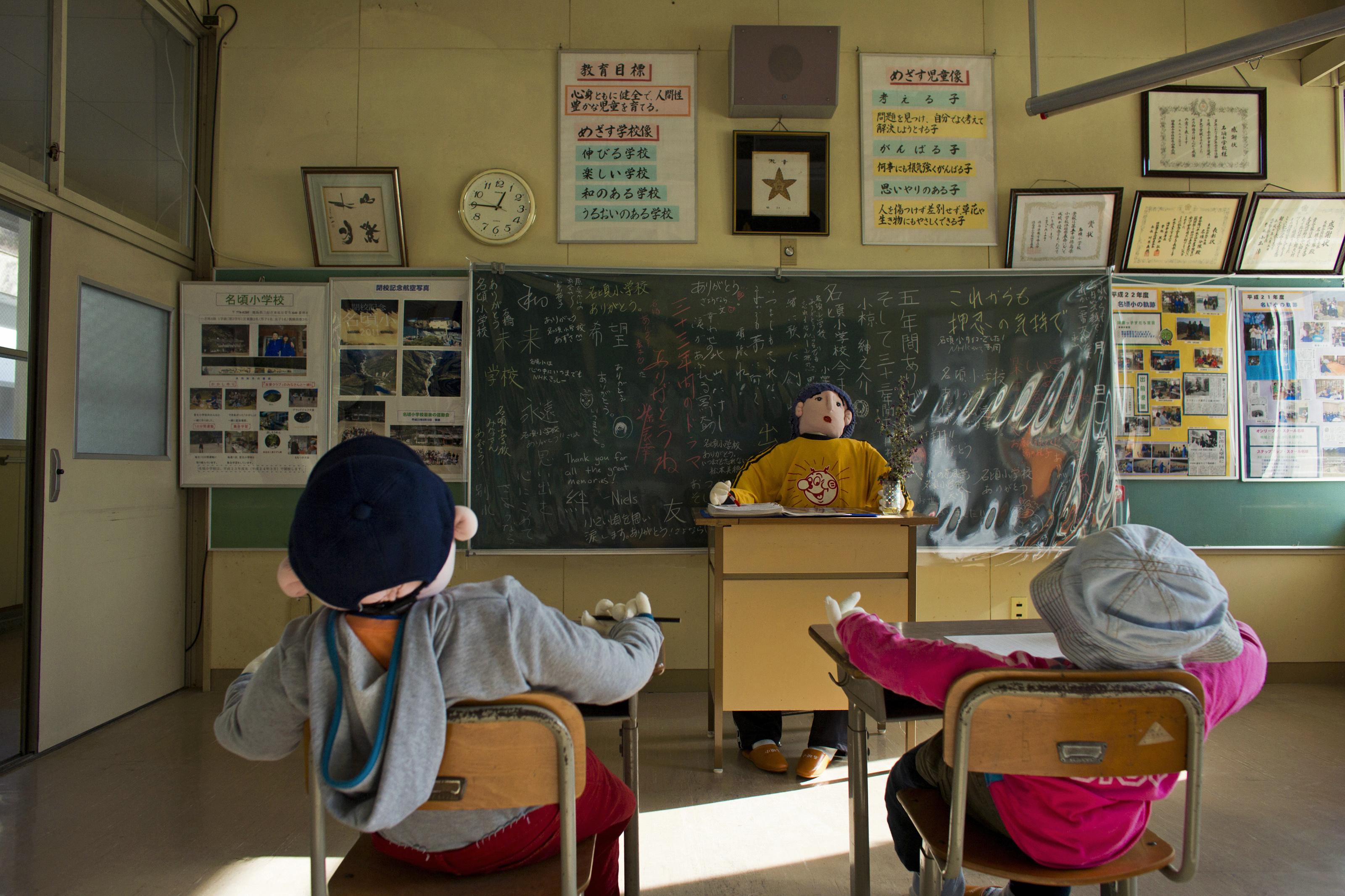 Scarecrows representing pupils and a teacher sit in a classroom in a closed down school in the village of Nagoro on Shikoku Island in southern Japan February 24, 2015.
