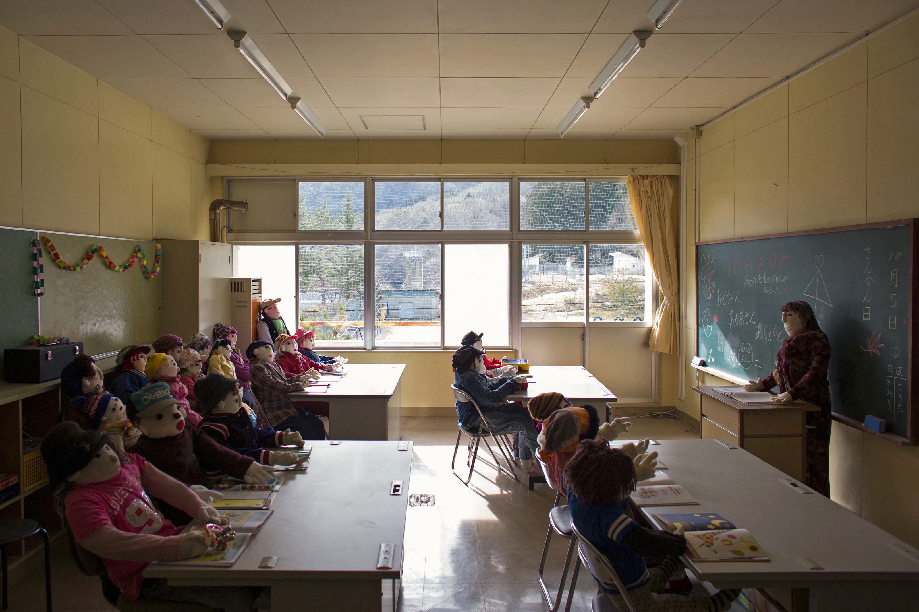 Scarecrows representing former pupils and a teacher sit in a classroom in a closed down school in the village of Nagoro on Shikoku Island in southern Japan February 24, 2015.