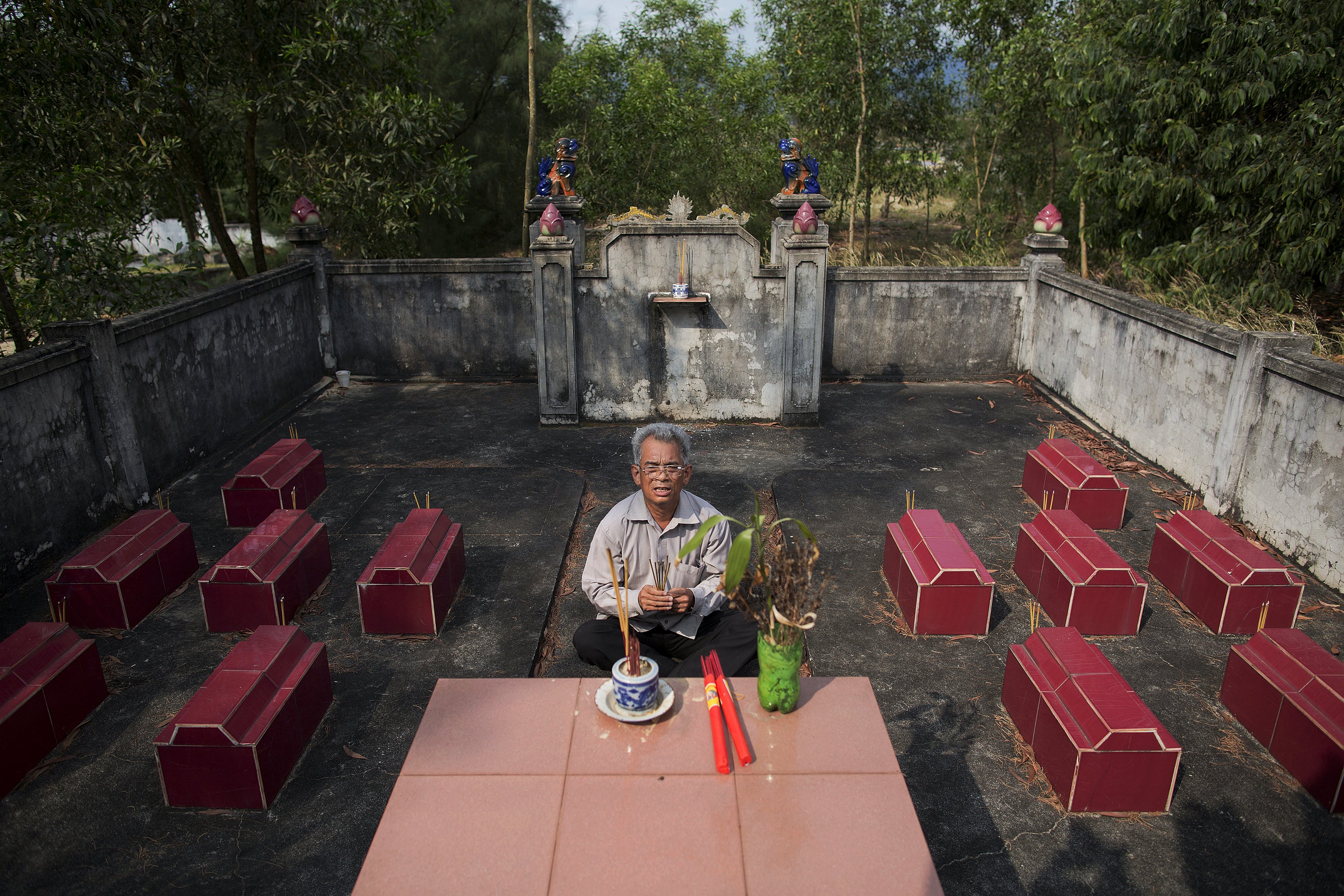 Former soldier Do Duc Diu prays at the cemetery where twelve of his children are buried, after showing the graves to reporters, near his house in Quang Binh Province in central Vietnam April 11, 2015. Twelve of his fifteen children died from illnesses that the family and their doctors link to Do Duc Diu's exposure to Agent Orange. Do Duc Diu served as a Vietnamese soldier from the North in the early 70s in areas that were heavily contaminated by Agent Orange. He only found out about the possible dangers of Agent Orange before his last child was born in 1994. He said that if he had known about the possible effects of Agent Orange he would not have had children. Before he found out about the effects of Agent Orange, Do Duc Diu said that he and his wife visited many spiritual leaders and prayed at different shrines as they attributed their children's sickness to their ill-fated destiny.