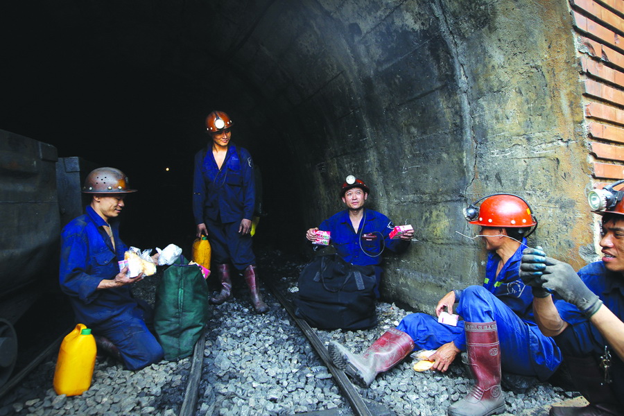A group of coal miners bring snacks including milk and bread for their co-workers working deep down in the mine.