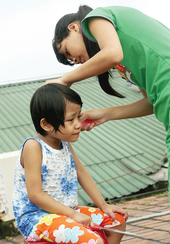 Once every month, Tin takes Tuyet (left) to the rooftop, where she cuts her hair and both do a good crying.