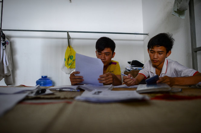 Nguyen Van Dat and Dinh Bat Hao from southern Binh Phuoc Province review their lessons the night before the exam in the Industrial University of Ho Chi Minh City’s boarding house, where they stay free-of-charge.