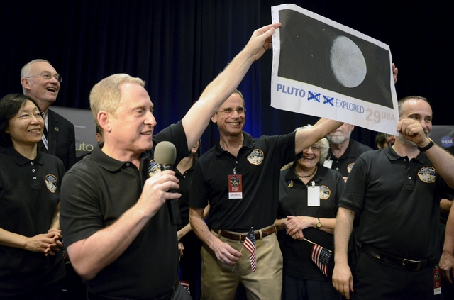 Pluto probe survives encounter, phones home