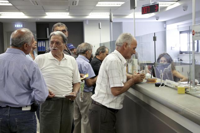 Banks reopen, first repayments start as Greece aims for return to normal