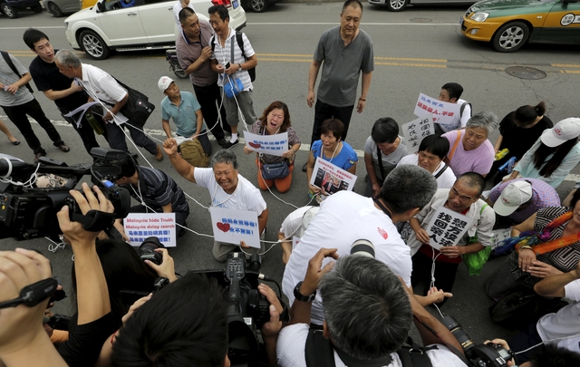 Malaysia seeks help, France widens search for MH370