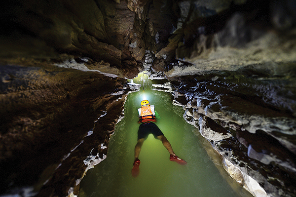 The only way to get deep into Ken Cave is swimming through its big river.