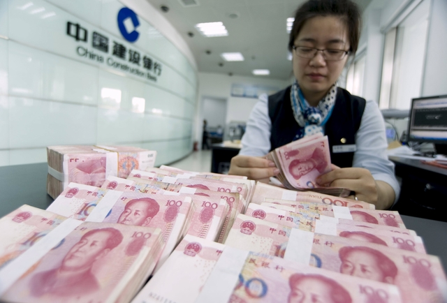 China tries to calm currency war fears as yuan slips further