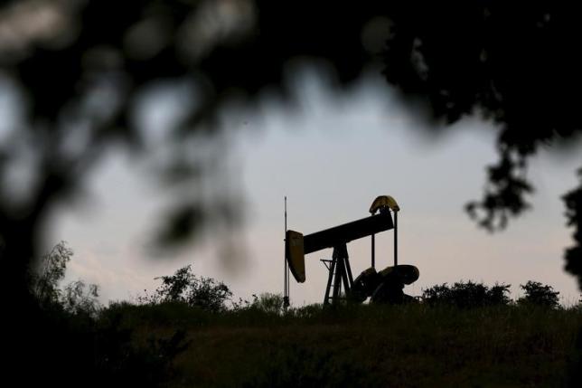 Oil skids toward 11-year low as IEA warns of worse glut