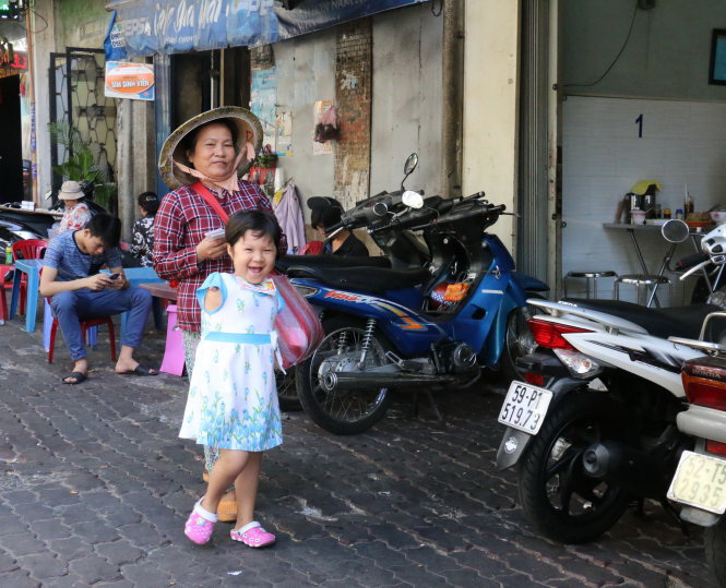 Armless little girl, grandma happy together in Ho Chi Minh City