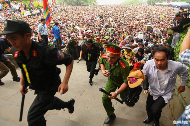 Millions of people race to the top of Nghia Linh Mountain after the barriers were cleared at 8:20 am on April 16, 2016 at the Hung Temples Relic Site in Phu Tho Province.