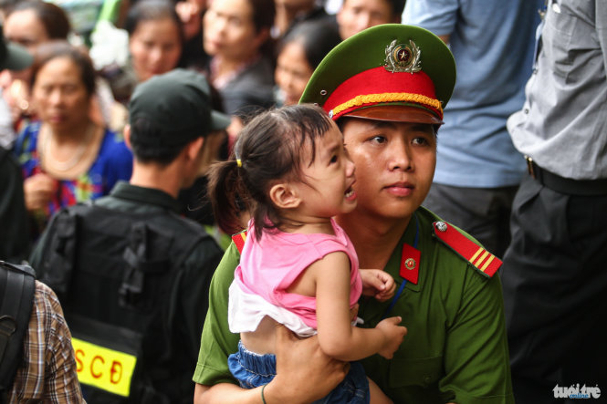 A girl cries as she is taken by a police officer away from her parents to a separate place for safety reasons during the Hung Kings festival at the Hung Temples Relic Site in Phu Tho Province, April 16, 2016.