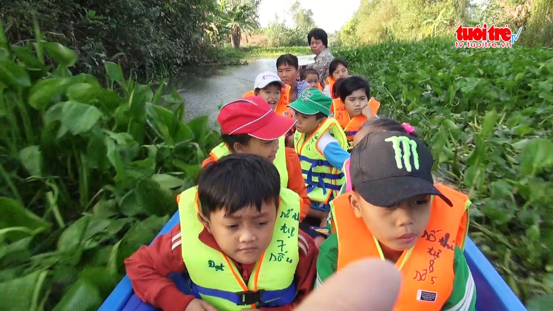 Old lady shuttling young students by boat for free