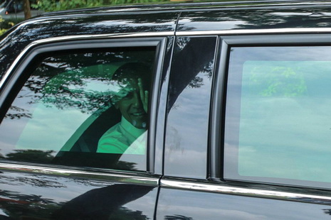 U.S. President Barack Obama waves goodbye from inside his private vehicle after visiting the former residence of late Vietnamese President Ho Chi Minh in Ba Dinh District, Hanoi on May 23, 2016.
