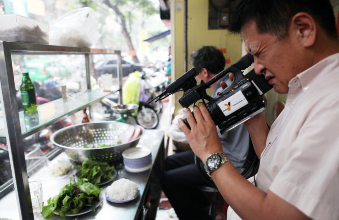 A cameraman is seen filming the dish.