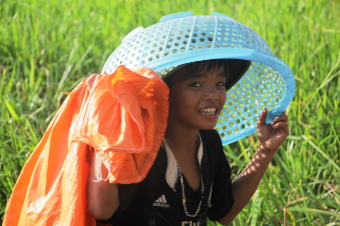 A youngster poses with a bag and a basket – his main fishing kit.