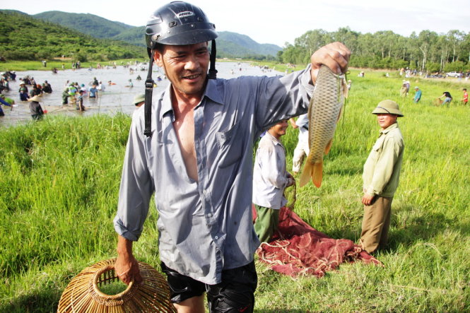 A man catches a carp at the festival.