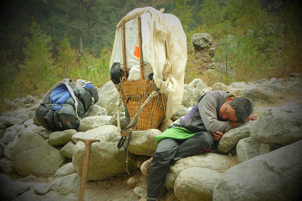 Ful. Bhahadur Tamang, a 40-year-old bearer, takes a quick nap along the path.