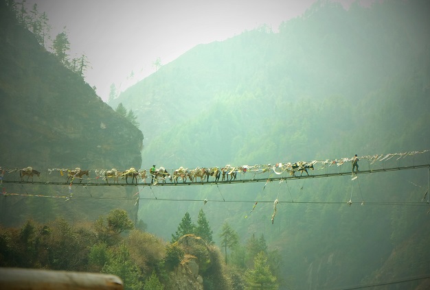 A suspension bridge connecting two summits in the Himalayas.