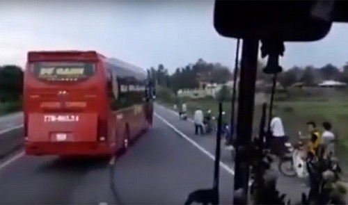 Passenger bus weaves through lanes in central Vietnam