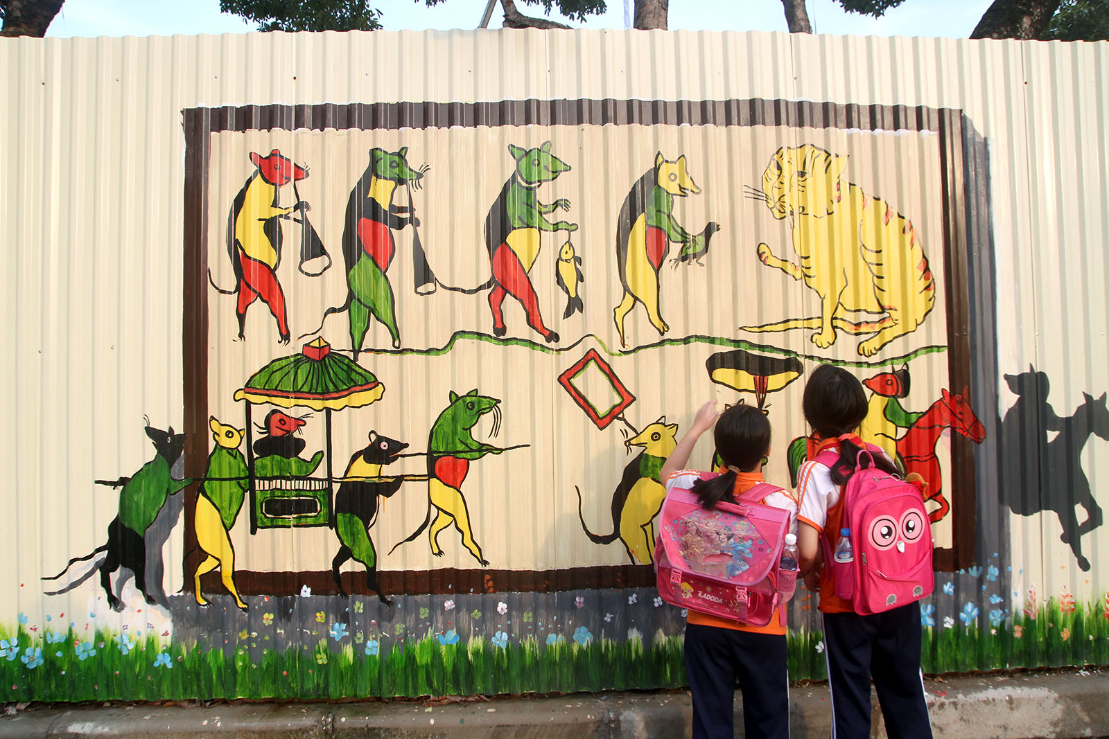 Two schoolgirls appreciate a Dong Ho painting. Photo: Tuoi Tre