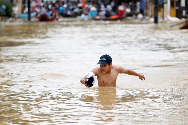 A man wades along a flooded by Typhoon Damrey street in the UNESCO heritage ancient town of Hoi An, Vietnam. Photo: Reuters