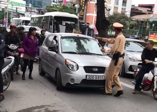 ‘Very busy’ Hanoi driver filmed inching car at police officer
