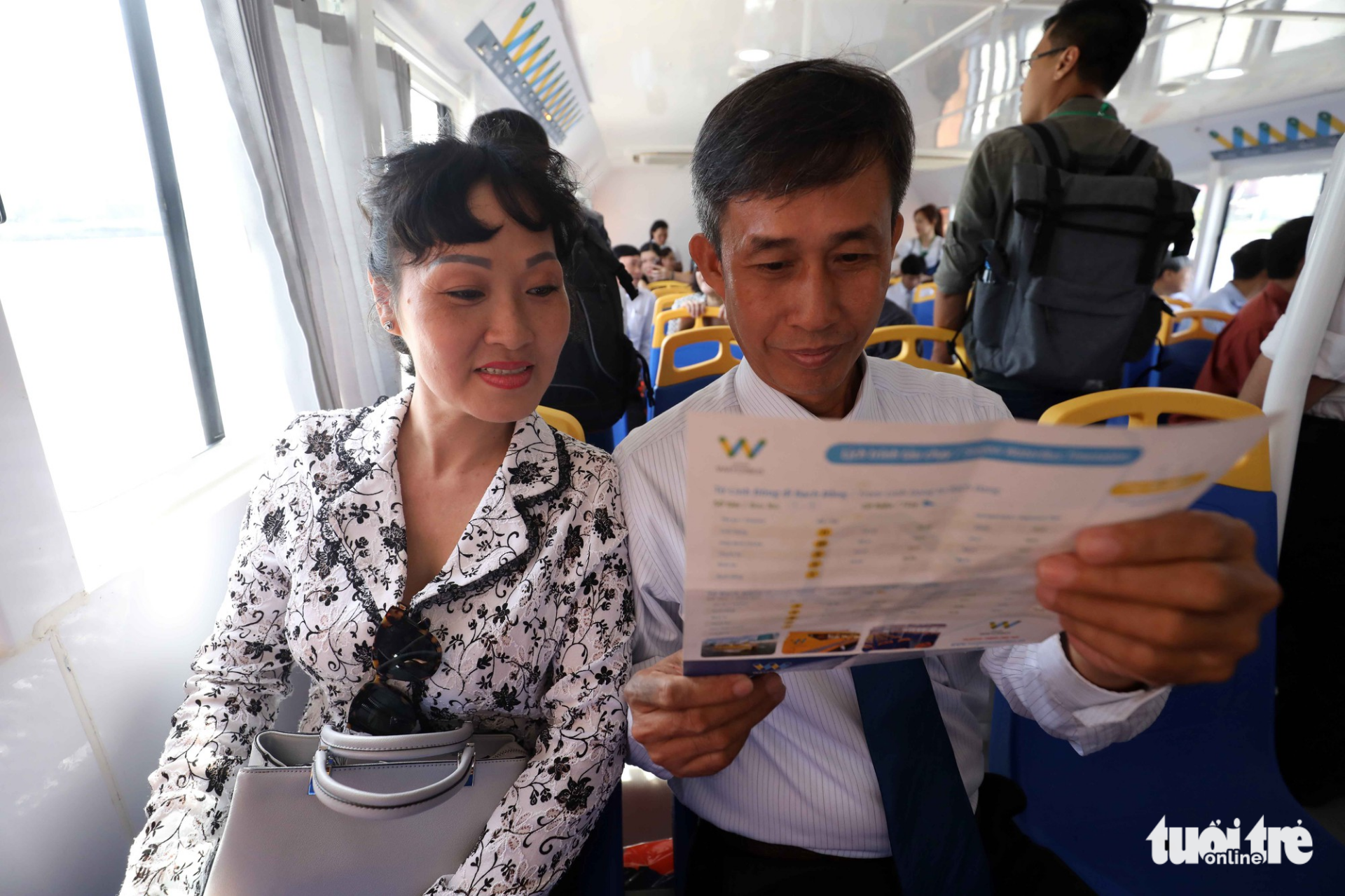 Passengers read the instructions on the river bus.