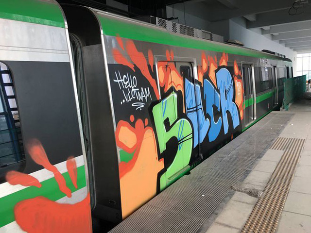 Trespassers scrawl graffiti over trains at Hanoi urban railway station  