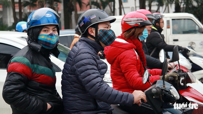 Commuters put on warm clothes to protect themselves against the chilly weather.