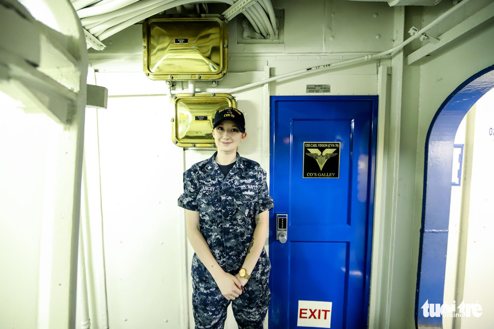 Delancey, 22, guides Vietnamese journalists through their tour on the USS Carl Vinson. Photo: Nguyen Khanh/Tuoi Tre