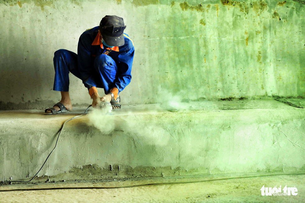 A worker finishes a concrete curb inside the first branch of the An Suong underpass in Ho Chi Minh City. Photo: Tuoi Tre