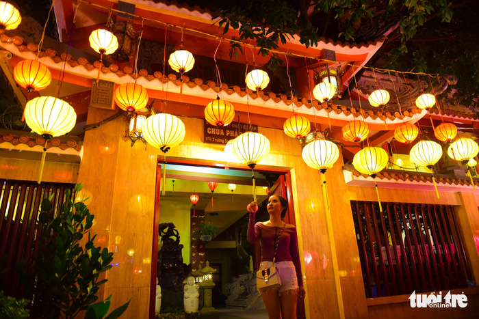 A woman watches the brightly-colored lanterns. Photo: Tuoi Tre