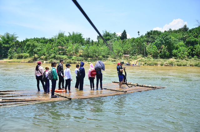 ​Defying currents, students ride bamboo raft to school in central Vietnam