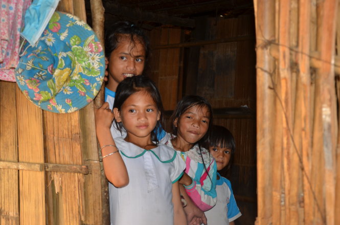 Children look out from a house in Quang Ngai Province, central Vietnam. Photo: Tuoi Tre