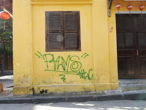 Hoi An’s signature yellow wall damaged by illicit graffiti