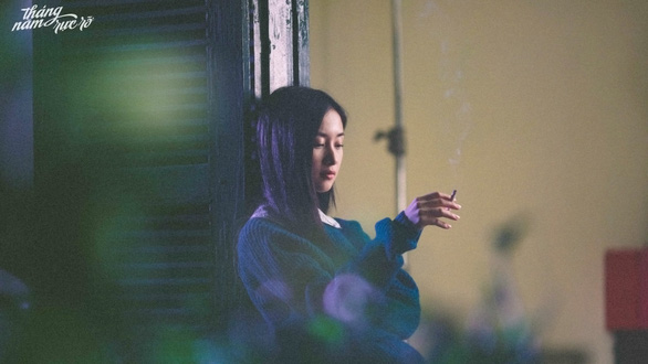 A scene from a Vietnamese movie showing a female character smoking.