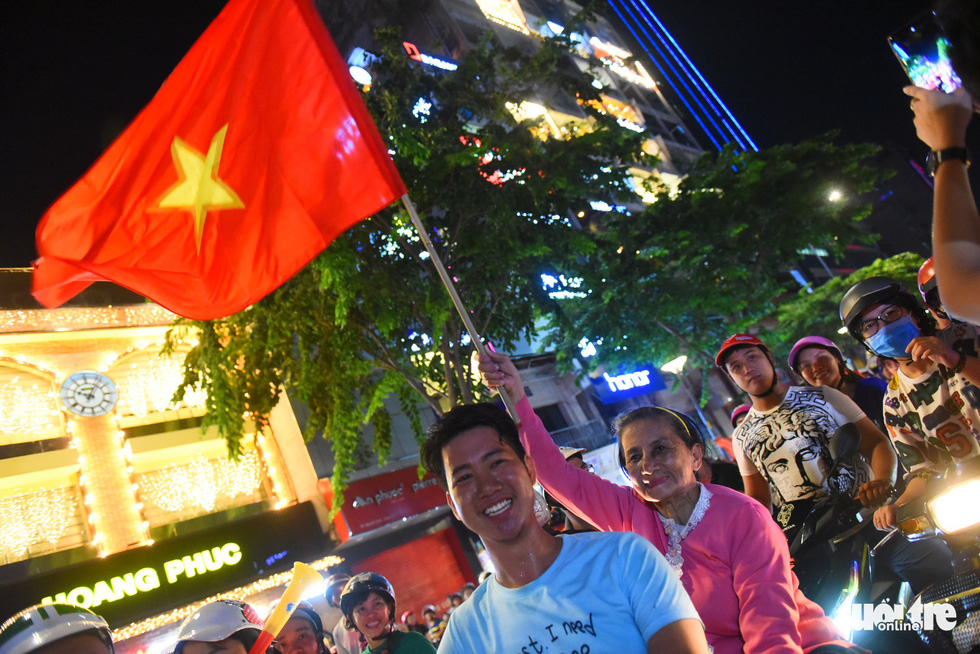 Football fans in Ho Chi Minh City celebrate Vietnam's 2-0 victory against Malaysia