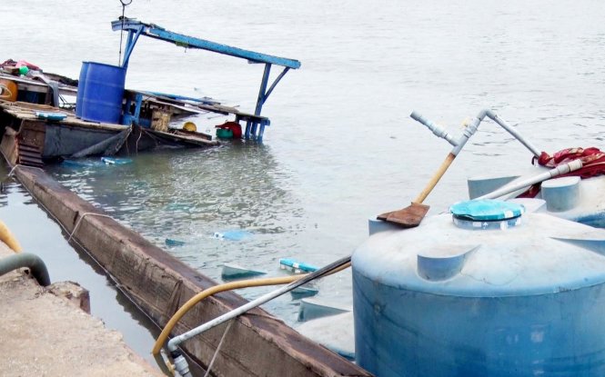 Boat transporting acid sinks in southern Vietnam