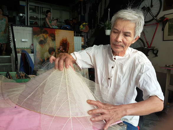 Vietnamese man makes traditional conical hat from almond leaf