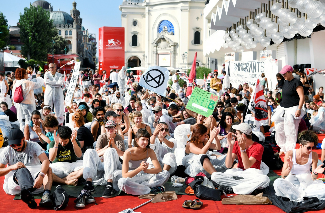 Climate change activists storm red carpet at Venice Film Festival