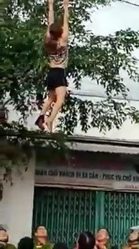 Woman allegedly high on drugs swings from power lines in Vietnam
