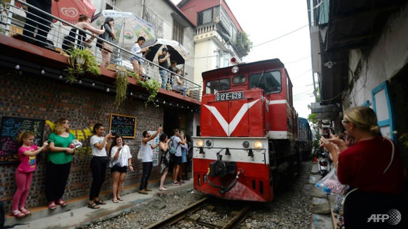 Hanoi begins clearing famed railway cafés after train pulls emergency brake to avoid tourists