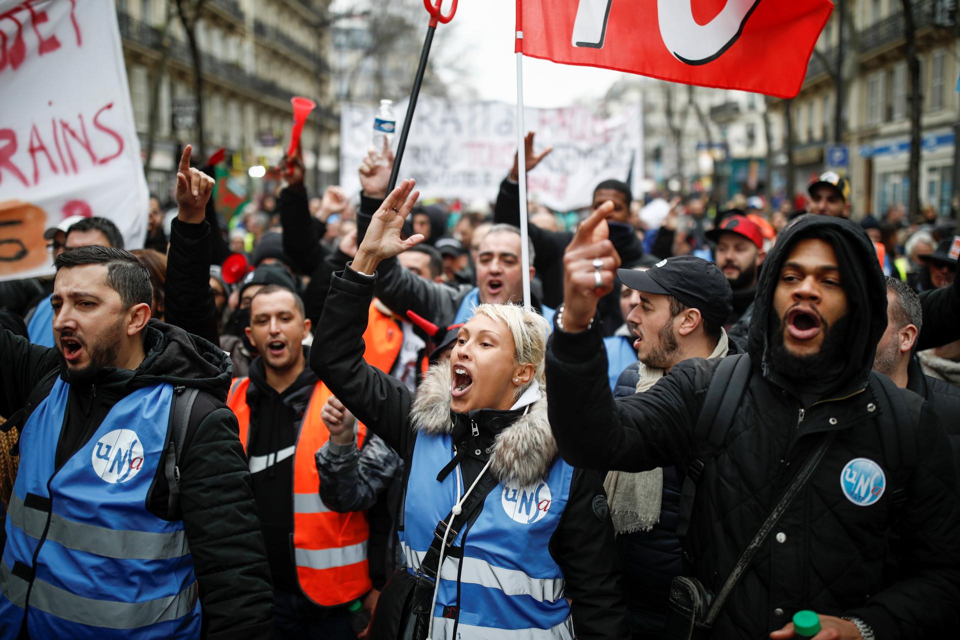 Scuffles break out in Paris as pensions protesters, 'yellow vests' march